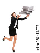 Woman in the office stumbling with a pile of folders in the hands, isolated on white. Business woman stumbling with folders. Стоковое фото, агентство Ingram Publishing / Фотобанк Лори