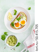 Toast with boiled egg, radish, cucumber and avocado pate. Top view. Стоковое фото, агентство Ingram Publishing / Фотобанк Лори