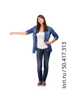 Beautiful woman standing over a white background with copyspace for the designer. Woman showing something. Стоковое фото, агентство Ingram Publishing / Фотобанк Лори