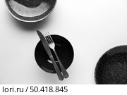 flat lay dark dinnerware with knife fork. Стоковое фото, агентство Ingram Publishing / Фотобанк Лори