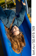 girl having fun slide outdoors. Стоковое фото, агентство Ingram Publishing / Фотобанк Лори