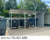 Russia, Mytishchi On June 24, 2025, black dumpsters are standing outside on a warm summer day. Редакционное фото, фотограф Соболева Наталия / Фотобанк Лори