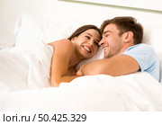 Young couple on bed and having a good time. Стоковое фото, агентство Ingram Publishing / Фотобанк Лори
