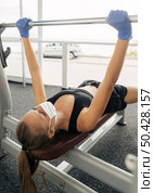 woman with medical mask gloves working out gym. Стоковое фото, агентство Ingram Publishing / Фотобанк Лори