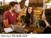 Group of friends studying together for finals. Стоковое фото, агентство Ingram Publishing / Фотобанк Лори