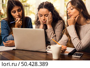 Group of friends studying together and worried with final exams. Стоковое фото, агентство Ingram Publishing / Фотобанк Лори