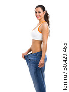 Woman with large jeans in dieting concept. Стоковое фото, агентство Ingram Publishing / Фотобанк Лори