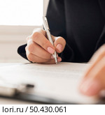 close up person signing certificate. Стоковое фото, агентство Ingram Publishing / Фотобанк Лори