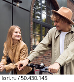 couple outdoors city with electric scooters. Стоковое фото, агентство Ingram Publishing / Фотобанк Лори