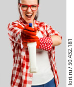 Pretty woman wearing gloves and holding a cleaning spray . Стоковое фото, агентство Ingram Publishing / Фотобанк Лори