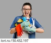 Portrait of a tired woman with hands full on cleaning stuff. Стоковое фото, агентство Ingram Publishing / Фотобанк Лори