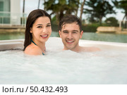 Young couple in a luxury hotel inside a jacuzzi enjoying the holidays. Стоковое фото, агентство Ingram Publishing / Фотобанк Лори