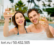 Young couple inside a jacuzzi and toasting . Стоковое фото, агентство Ingram Publishing / Фотобанк Лори