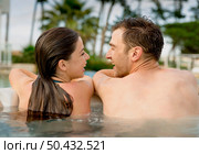 Young couple in a luxury hotel inside a jacuzzi enjoying the holidays. Стоковое фото, агентство Ingram Publishing / Фотобанк Лори