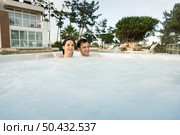Young couple in a luxury hotel inside a jacuzzi in a rainy day . Стоковое фото, агентство Ingram Publishing / Фотобанк Лори