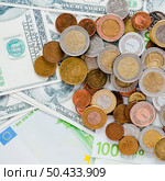 close up spread coins us one hundred dollar bills. Стоковое фото, агентство Ingram Publishing / Фотобанк Лори