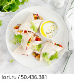 Greek chicken wraps souvlaki with vegetables and tzatziki sause. Top view. Стоковое фото, агентство Ingram Publishing / Фотобанк Лори