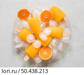 flat lay yummy orange flavored popsicles with ice. Стоковое фото, агентство Ingram Publishing / Фотобанк Лори