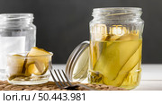 front view pickled cucumbers glass jars. Стоковое фото, агентство Ingram Publishing / Фотобанк Лори