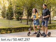 cute young couple riding scooter outdoors 2. Стоковое фото, агентство Ingram Publishing / Фотобанк Лори