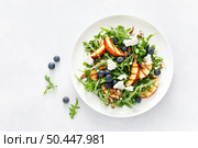 Peach, blueberry and arugula fresh fruit salad with cheese and almond nuts, top view. Стоковое фото, агентство Ingram Publishing / Фотобанк Лори