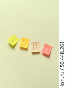 ADHD abbreviation written on sticky notes over beige backdrop. Attention deficit hyperactivity disorder and mental health awareness.. ADHD written on sticky notes. Стоковое фото, агентство Ingram Publishing / Фотобанк Лори