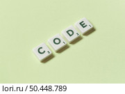 Code word formed of scrabble elements on green background, still life with copy space.. Code formed of scrabble elements on green background. Стоковое фото, агентство Ingram Publishing / Фотобанк Лори
