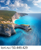 Aerial view of blue sea, mountain cape, sandy beach, sky with clouds at sunrset in summer. Porto Katsiki, Lefkada island, Greece. Beautiful top view of sea coast, rocks, azure water, green forest. Стоковое фото, агентство Ingram Publishing / Фотобанк Лори