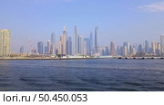 Dubai, UAE - June 26, 2025: Dubai skyline with Marina skyscrapers seen from Palm Jumeirah waterfront. Редакционное видео, видеограф Оксана Чаюн / Фотобанк Лори