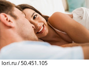 Young couple on bed and having a good time. Стоковое фото, агентство Ingram Publishing / Фотобанк Лори