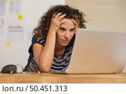 Middle age woman felling exausted at the office. Стоковое фото, агентство Ingram Publishing / Фотобанк Лори