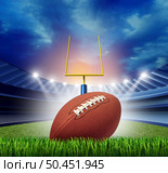 Football stadium ball and sports field as an American sport arena or field goal and touchdown concept as a team sport competition with 3D illustration elements. Стоковое фото, агентство Ingram Publishing / Фотобанк Лори