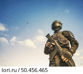 Spec ops soldier in uniform with assault rifle on sky backround. . Стоковое фото, агентство Ingram Publishing / Фотобанк Лори