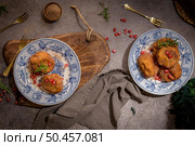 Rabanadas poveiras with sugar and cinnamon and some pomegranate seeds on a rustic kitchen countertop during the Christmas season. Стоковое фото, агентство Ingram Publishing / Фотобанк Лори