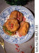 Rabanadas poveiras with sugar and cinnamon and some pomegranate seeds on a rustic kitchen countertop during the Christmas season. Стоковое фото, агентство Ingram Publishing / Фотобанк Лори