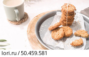 Breakfast concept with baked butter cookies, cappuccino coffee with creamy foam in ceramic cup. Стоковое фото, агентство Ingram Publishing / Фотобанк Лори