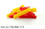 Closeup of colorful plastic dowels isolated on white background. Стоковое фото, агентство Ingram Publishing / Фотобанк Лори