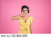 Young woman covering her mouth showing shut up. Стоковое фото, агентство Ingram Publishing / Фотобанк Лори
