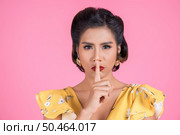 Beauty asian woman red lips and finger showing hush silence sign. Стоковое фото, агентство Ingram Publishing / Фотобанк Лори