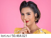 Beauty asian woman red lips and finger showing hush silence sign. Стоковое фото, агентство Ingram Publishing / Фотобанк Лори