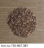 Top view of  chia seeds against green vinyl background. Стоковое фото, агентство Ingram Publishing / Фотобанк Лори