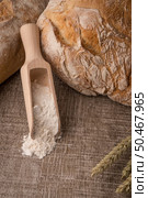 Rustic bread and wheat on an old vintage planked wood table. Стоковое фото, агентство Ingram Publishing / Фотобанк Лори