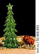 Christmas tree decorations made out of green sequins on golden cloth and dark background. Стоковое фото, агентство Ingram Publishing / Фотобанк Лори