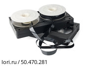 Two videotapes and reel on  white reflective background. Стоковое фото, агентство Ingram Publishing / Фотобанк Лори