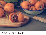 loquats on kitchen counter background. Vintage style. Стоковое фото, агентство Ingram Publishing / Фотобанк Лори