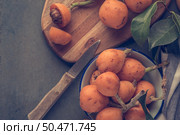 loquats on kitchen counter background. Vintage style. Стоковое фото, агентство Ingram Publishing / Фотобанк Лори
