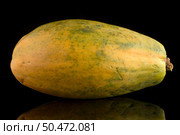Papaya isolated on a black background. Стоковое фото, агентство Ingram Publishing / Фотобанк Лори