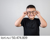 Funny boy genius wearing glasses in studio shot. Стоковое фото, агентство Ingram Publishing / Фотобанк Лори