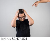Boy feels sad after the parents scold him. Стоковое фото, агентство Ingram Publishing / Фотобанк Лори