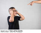 Boy feels sad after the parents scold him. Стоковое фото, агентство Ingram Publishing / Фотобанк Лори
